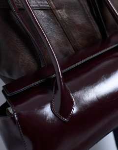 Model wearing Sally folded bag in burgundy