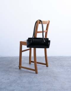 Model wearing Sally medium folded bag in black