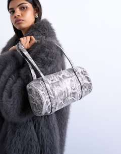 Model wearing Salma bowler bag in snake