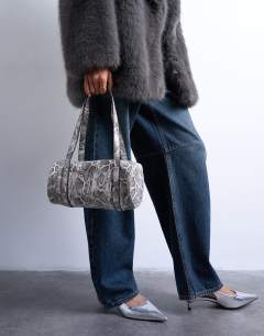 Model wearing Salma bowler bag in snake