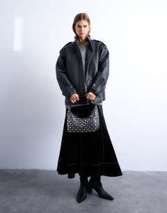 Model wearing Samantha studded shoulder bag in black