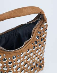 Model wearing Samantha studded shoulder bag in tan