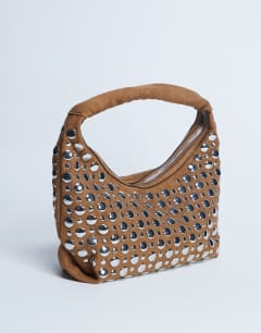 Model wearing Samantha studded shoulder bag in tan