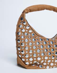 Model wearing Samantha studded shoulder bag in tan