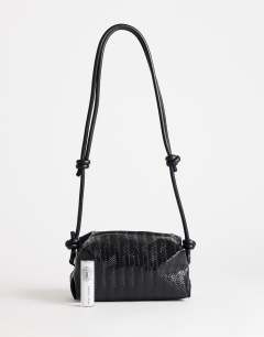 Model wearing Samara small weave cross body bag in black