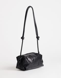 Model wearing Samara small weave cross body bag in black