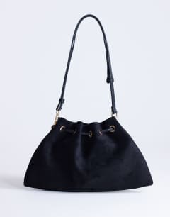 Model wearing Sammy ruched drawstring shoulder bag in black