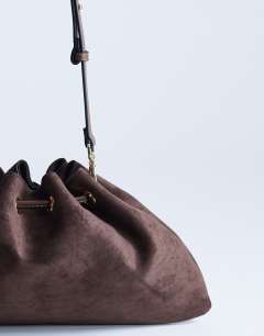 Model wearing Sammy ruched drawstring shoulder bag in tan