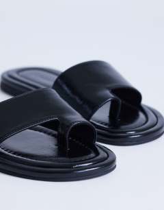 Model wearing Sandra flat sandal mule in black