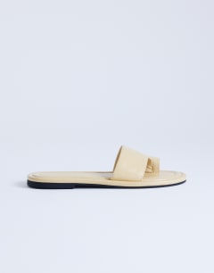 Model wearing Sandra flat sandal mule in buttermilk