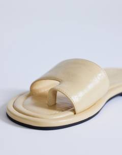 Model wearing Sandra flat sandal mule in buttermilk