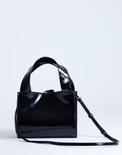 Model wearing Sandy small real suede and leather grab bag with tie fastening in black