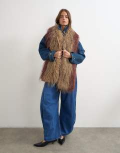 Model wearing Sandy wispy faux fur scarf in brown and burgundy