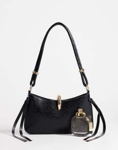 Model wearing Sansa small shoulder bag with hardware in black