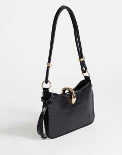 Model wearing Sansa small shoulder bag with hardware in black