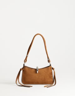 Model wearing Sansa small shoulder bag with hardware in tan