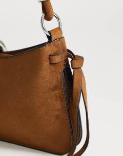 Model wearing Sansa small shoulder bag with hardware in tan