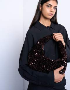 Model wearing Santana scoop sequin shoulder bag in chocolate