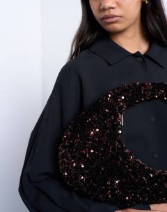 Model wearing Santana scoop sequin shoulder bag in chocolate
