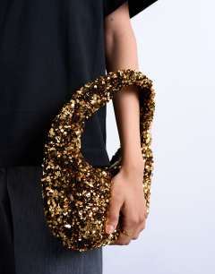Model wearing Santana scoop sequin shoulder bag in gold