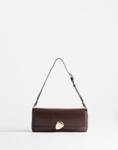 Model wearing Santiago small shoulder bag with gold hardware in chocolate