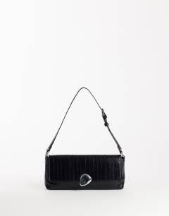 Model wearing Santiago small suedette shoulder bag with silver hardware in black