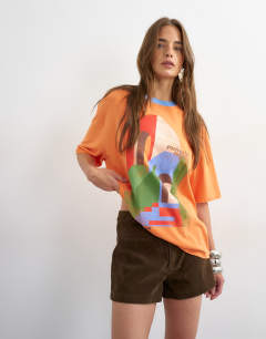 Model wearing Topshop 'Santorini Nights' graphic oversized tee in orange