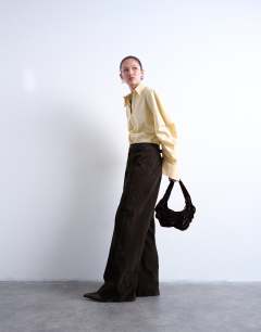 Model wearing Saphire ruched velvet shoulder bag in chocolate
