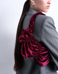 Model wearing Saphire ruched velvet shoulder bag in plum