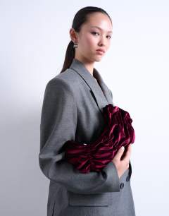 Model wearing Saphire ruched velvet shoulder bag in plum