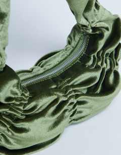 Model wearing Sapphire ruched velvet shoulder bag in khaki
