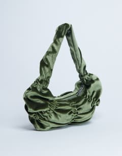 Model wearing Sapphire ruched velvet shoulder bag in khaki