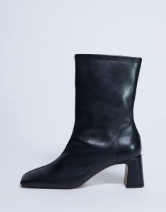 Model wearing Sara Premium leather square toe flared heel boot in black