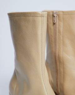 Model wearing Sara Premium leather square toe flared heel boot in buttermilk