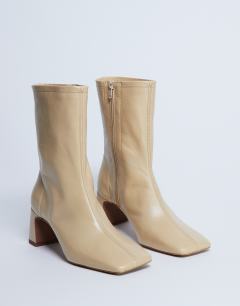 Model wearing Sara Premium leather square toe flared heel boot in buttermilk