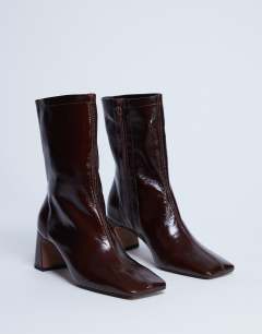 Model wearing Sara Premium leather square toe flared heel boot in chocolate 