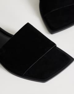 Model wearing Sara real suede mule flat sandal in black