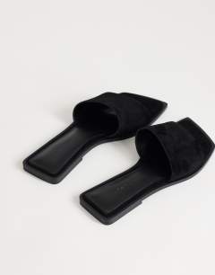 Model wearing Sara real suede mule flat sandal in black