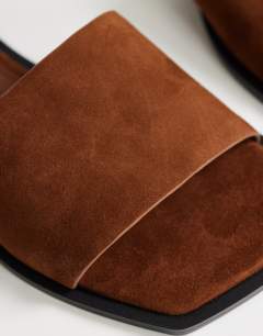 Model wearing Sara real suede mule flat sandal in tan