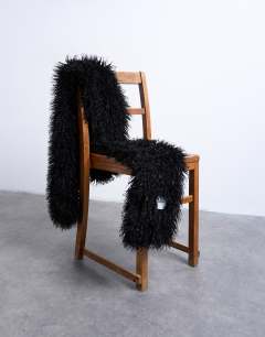 Model wearing Sara shaggy faux fur blanket scarf in black