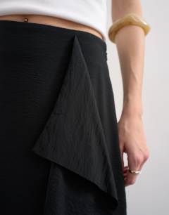 Model wearing Sarong wrap midi skirt in black