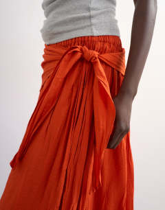 Model wearing Sash tie crinkle full maxi skirt in orange