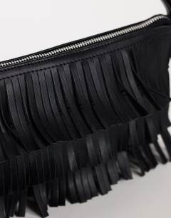 Model wearing Sasha small fringe shoulder bag in black
