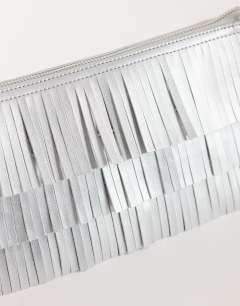 Model wearing Sasha small fringe shoulder bag in silver