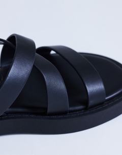 Model wearing Sasha strappy flat sandal in black