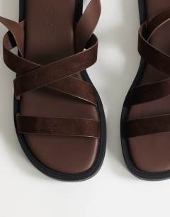 Model wearing Sasha strappy flat sandal in chocolate