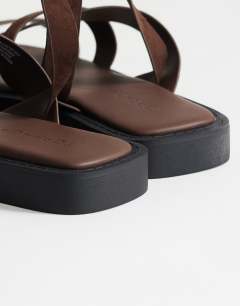 Model wearing Sasha strappy flat sandal in chocolate