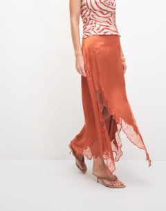 Model wearing Satin and lace hanky hem midi skirt in rust