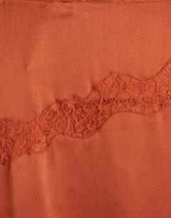 Model wearing Satin and lace hanky hem midi skirt in rust