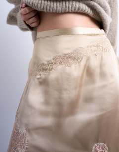 Model wearing Satin and lace mix hanky hem midi skirt in taupe